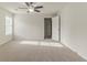 Bright main bedroom featuring neutral carpet and a ceiling fan at 3717 Lockerbie Ln, Powder Springs, GA 30127