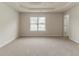 Spacious main bedroom with a tray ceiling, neutral carpeting, and plenty of natural light at 3717 Lockerbie Ln, Powder Springs, GA 30127
