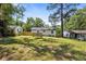A full view of the backyard reveals a spacious, well-kept lawn, a cozy deck, and partial fencing around the property at 4134 Burgess Dr, Decatur, GA 30035