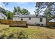 White home's backyard features a small wooden deck and a well-maintained grassy area at 4134 Burgess Dr, Decatur, GA 30035