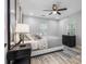 Bright bedroom features a ceiling fan, neutral color scheme, and wood-look flooring at 4134 Burgess Dr, Decatur, GA 30035