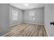 Spacious bedroom featuring neutral walls, wood-look floors, and bright lighting at 4134 Burgess Dr, Decatur, GA 30035