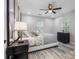 Comfortable bedroom featuring a ceiling fan, large windows, and a stylish accent rug at 4134 Burgess Dr, Decatur, GA 30035