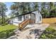 Charming renovated home featuring freshly painted siding, wooden stairs, and a well-maintained front yard at 4134 Burgess Dr, Decatur, GA 30035
