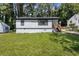 Beautiful home featuring manicured lawn, white siding, and black trim at 4134 Burgess Dr, Decatur, GA 30035