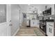 Stylish kitchen with white cabinets, stainless steel appliances, and eat-in breakfast bar at 4134 Burgess Dr, Decatur, GA 30035