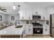 Bright kitchen with white cabinets, stainless appliances, and a view into the open-concept living area at 4134 Burgess Dr, Decatur, GA 30035