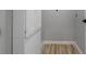 Small laundry area featuring white cabinets and wood-look flooring at 4134 Burgess Dr, Decatur, GA 30035