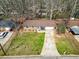 Aerial view of a well-maintained home featuring a manicured lawn and a long driveway at 2954 Ann Marie Ln, Rex, GA 30273