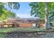 Backyard of a brick home with a wooden deck and stairs leading to the yard at 2954 Ann Marie Ln, Rex, GA 30273