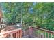 Backyard featuring a wood deck with a wooden railing and mature trees at 2954 Ann Marie Ln, Rex, GA 30273
