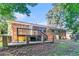Backyard of a brick home with a wooden deck and stairs leading to the yard at 2954 Ann Marie Ln, Rex, GA 30273