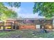Backyard of a brick home with a wooden deck and stairs leading to the yard at 2954 Ann Marie Ln, Rex, GA 30273