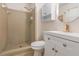 Bathroom featuring tiled shower, modern vanity with updated fixtures, and stylish circular mirror at 2954 Ann Marie Ln, Rex, GA 30273