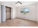 Bright bedroom with wood floors, a ceiling fan, closet, and a large window overlooking the neighborhood at 2954 Ann Marie Ln, Rex, GA 30273