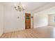 Bright dining area with modern flooring and classic chandelier fixture at 2954 Ann Marie Ln, Rex, GA 30273
