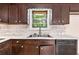 A well-equipped kitchen featuring white countertops, subway tile backsplash, and stainless steel sink at 2954 Ann Marie Ln, Rex, GA 30273