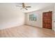 Bright living room with new laminate flooring, ceiling fan, and fresh paint at 2954 Ann Marie Ln, Rex, GA 30273