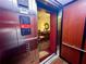 Modern elevator with stainless steel and wood finishes leads to a carpeted foyer at 3302 Dogwood Dr # 328, Atlanta, GA 30354