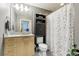 Bathroom featuring a light wood vanity and shower with decorative curtain at 361 17Th Nw St # 2315, Atlanta, GA 30363
