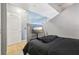 Bedroom with light wood floors, concrete ceiling, and mounted TV at 361 17Th Nw St # 2315, Atlanta, GA 30363