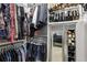 Organized walk-in closet with hanging clothes and shelves for shoes at 361 17Th Nw St # 2315, Atlanta, GA 30363