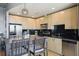 Modern kitchen features stainless steel appliances, black backsplash, and an open layout with dining area at 361 17Th Nw St # 2315, Atlanta, GA 30363