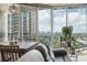 Cozy living room showcasing city views through large windows with dining table and hardwood floors at 361 17Th Nw St # 2315, Atlanta, GA 30363