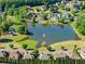 Aerial shot of a pond community featuring a peaceful gazebo and lush landscaping at 4680 Brighton Lake Dr, Cumming, GA 30040