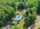 Stunning aerial view featuring a private pool, volleyball court, playground, and lush greenery at 4680 Brighton Lake Dr, Cumming, GA 30040