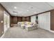 Finished basement with neutral carpet, a large sectional sofa, and a walkout to the backyard at 4680 Brighton Lake Dr, Cumming, GA 30040