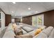 Finished basement with a large sectional sofa, neutral carpet and walkout to the backyard at 4680 Brighton Lake Dr, Cumming, GA 30040