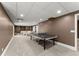 Spacious finished basement with carpet flooring, a ping pong table, and neutral colored walls at 4680 Brighton Lake Dr, Cumming, GA 30040