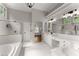 Bright bathroom with bathtub, walk-in shower, double sink vanity, and large mirror at 4680 Brighton Lake Dr, Cumming, GA 30040