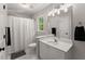 Bright bathroom featuring a white vanity, shower-tub with white curtain, and neutral walls at 4680 Brighton Lake Dr, Cumming, GA 30040