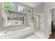 Bright bathroom with bathtub, walk-in shower, double sink vanity, and large windows at 4680 Brighton Lake Dr, Cumming, GA 30040