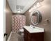 Cozy bathroom featuring a decorative mirror and a patterned shower curtain at 4680 Brighton Lake Dr, Cumming, GA 30040