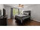Bedroom with hardwood flooring, ceiling fan, and a window with natural light at 4680 Brighton Lake Dr, Cumming, GA 30040