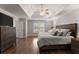 Main bedroom featuring tray ceilings, hardwood floors, and neutral wall color at 4680 Brighton Lake Dr, Cumming, GA 30040
