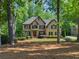 Classic brick home with mature trees, manicured lawn, and a welcoming front entrance; a picturesque Gathering residence at 4680 Brighton Lake Dr, Cumming, GA 30040