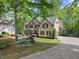 Stunning brick home with manicured front lawn, flowering bushes, and convenient side entry garage at 4680 Brighton Lake Dr, Cumming, GA 30040