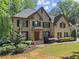 Beautiful two-story brick home features manicured landscaping, dark shutters, and an inviting front entrance at 4680 Brighton Lake Dr, Cumming, GA 30040