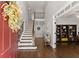 Inviting foyer featuring hardwood floors, a grand staircase, and views into the adjacent living spaces at 4680 Brighton Lake Dr, Cumming, GA 30040