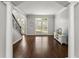 Inviting living room with hardwood floors, arched entryway, and view to a staircase, offering a warm ambiance at 4680 Brighton Lake Dr, Cumming, GA 30040
