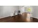 Bright living room boasting hardwood floors and natural light streaming through a window showcasing the outdoor view at 4680 Brighton Lake Dr, Cumming, GA 30040