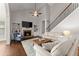 Bright living room featuring a fireplace, built-in shelving, soaring ceilings, and hardwood flooring at 4680 Brighton Lake Dr, Cumming, GA 30040