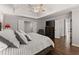 Spacious main bedroom with tray ceiling, ceiling fan, and beautiful hardwood floors at 4680 Brighton Lake Dr, Cumming, GA 30040