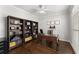 Stylish home office featuring custom built-in bookshelves, hardwood floors, and a classic wooden desk at 4680 Brighton Lake Dr, Cumming, GA 30040