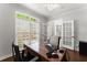 Bright office space featuring a large window, hardwood floors, and a classic wooden desk, perfect for productivity at 4680 Brighton Lake Dr, Cumming, GA 30040