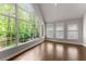 Bright sunroom with large windows offering a beautiful view of the outdoors and hardwood floors at 4680 Brighton Lake Dr, Cumming, GA 30040